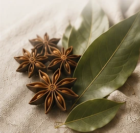 Whole star anise pods beside bay leaves